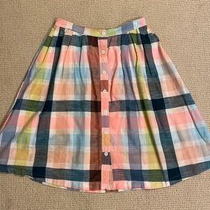 Knee length skirt with button placket down the front, elastic back waist band.